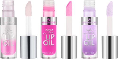 Three lip oils with pink, purple, and clear shades, each with a built-in applicator brush.