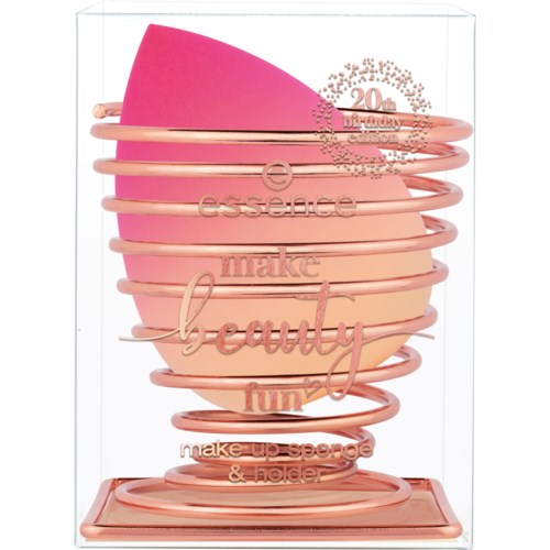 Pink makeup sponge with a rose gold wire holder and decorative text.