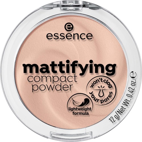 En rund kompakt med beige puder, svart och rosa text, och ett tydligt lock som visar innehållet.