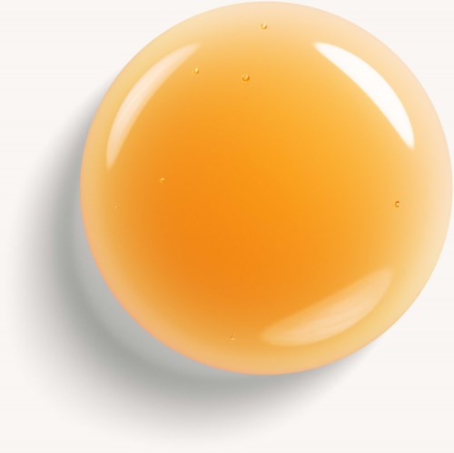 Et rundt, orange farvet objekt med en blank, glat overflade. Det har små vanddråber på sig og kaster en skygge.