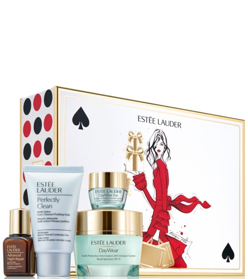 Et gaveesett med Estée Lauder-produkter og en boks med en kvinne i rødt med juletema.