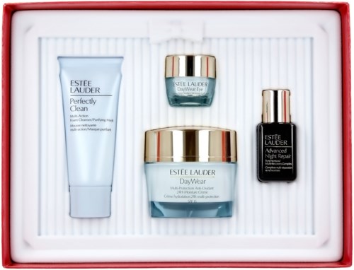 En uppsättning Estée Lauder hudvårdsprodukter med kräm, mask, serum och fuktighetskräm, ordnade i en vit bricka i en röd ask.
