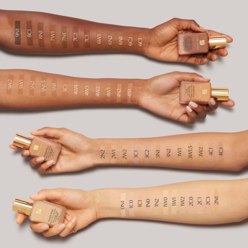 Swatches of various foundation shades are shown on four arms, each labeled with a number or letter code.