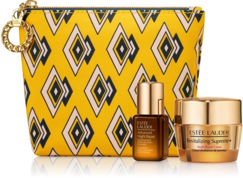 En gul mönstrad väska med guldzippar, inklusive Estee Lauder hudvårdsprodukter, ett litet serum och kräm.