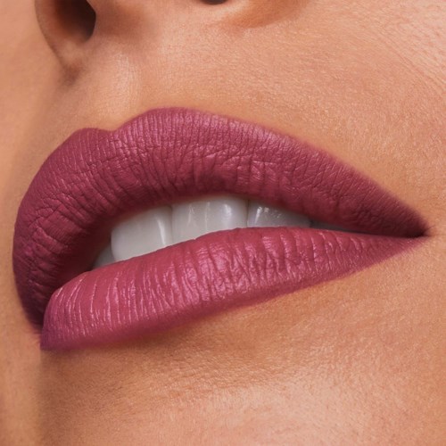 Close-up van lippen die licht gescheiden zijn, met witte tanden en roze lippenstift.