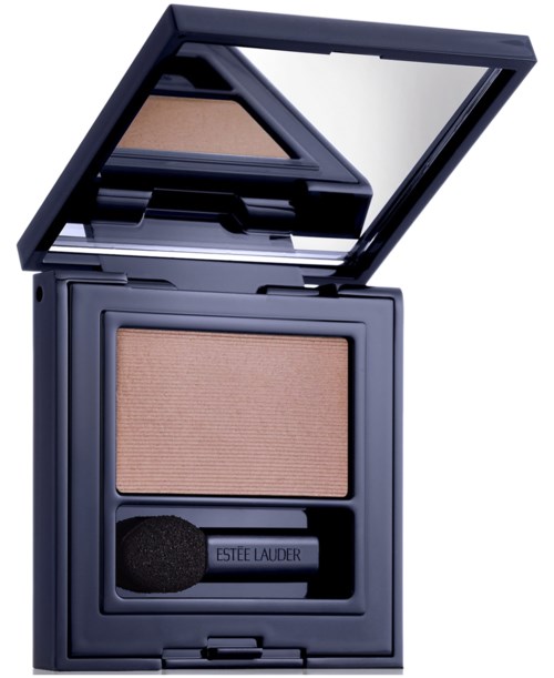 A compact makeup mirror with a beige eyeshadow and an applicator inside. The mirror is open, showing a reflective surface.
