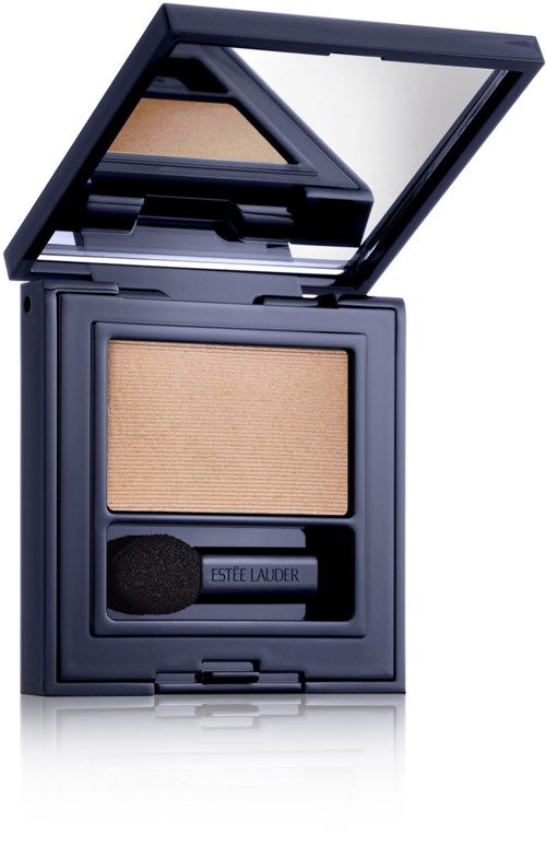A compact makeup case with beige powder and a small applicator sponge inside a dark blue container.