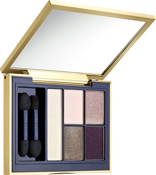 A makeup palette with six eyeshadow colors and two small brushes inside a gold case.