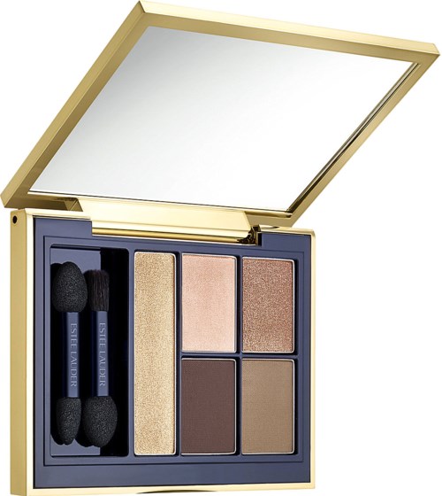 A makeup palette with four eyeshadow shades, brushes, and a mirror. Gold and blue case. Flat and compact design.