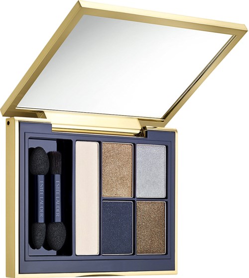 A makeup palette with six eyeshadow shades, two brushes, and a mirror. The palette has a gold and navy design.