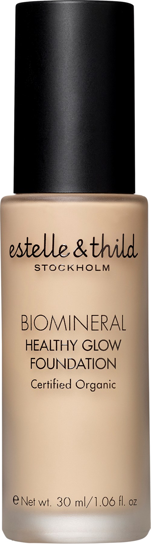 A beige foundation bottle with a black cap, labeled Estelle & Thild Biomineral, Healthy Glow Foundation, certified organic.