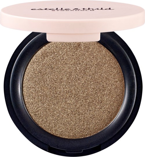 En rund makeup-produkt med gyllene glitter inuti och ett vitt lock. Varumärkesnamnet är delvis synligt på locket.