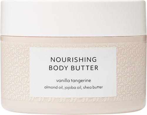 Nærende kropsbutter i en hvid beholder med beige midtstykke, mærket vanilje-tangerine med ingredienser mandel olie, jojoba olie og sheasmør.