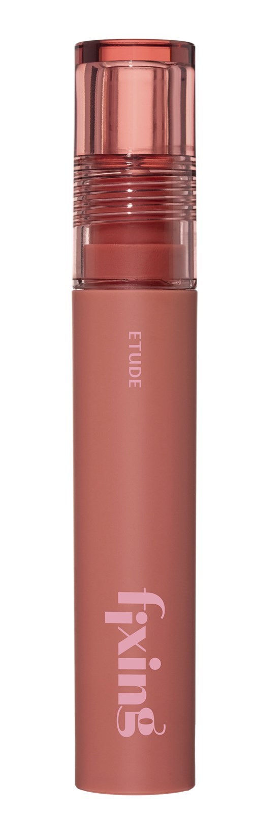 Et rosa, sylinderformet kosmetikkprodukt med gjennomsiktig lokk og ordene Fixing og Eude skrevet på den.