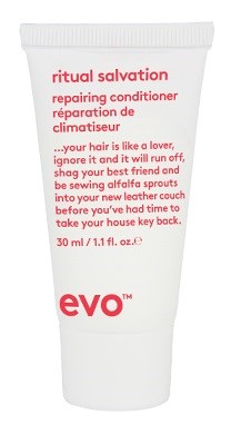 A white tube of Ritual Salvation repair conditioner with red text, mentioning hair love, spraying into your head, and taking back control.