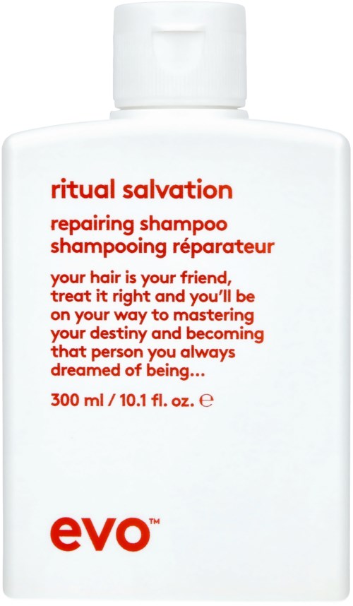 En hvit flaske merket 'ritual salvation repairing shampoo' med rød og svart tekst, og en liten logo nederst.