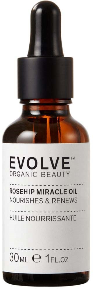 A small brown bottle with a dropper, labeled Evolve Organic Beauty, Rosehip Miracle Oil for skin care.