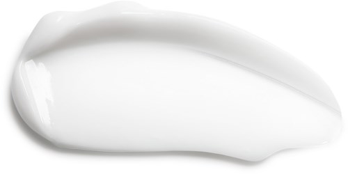 Weiße Creme in einer kleinen, gebogenen Form auf schwarzem Hintergrund.