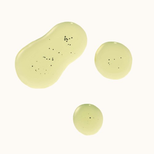 Three irregular greenish blobs with black dots inside, one large and two smaller. They look like drops or blobs.