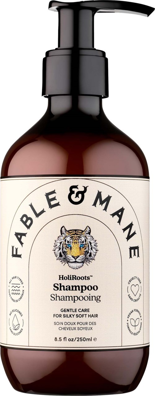 A brown shampoo bottle with a black pump labeled Fable & Mane HoliRoots Shampoo, suitable for soft, silky hair.