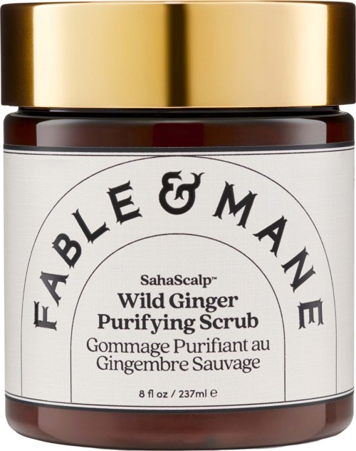 A jar of Fable & Mame Wild Ginger Purifying Scrub with a gold lid and white label.