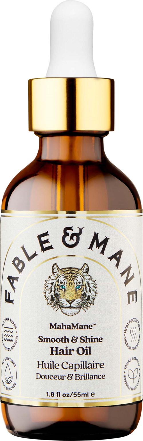 A brown glass bottle with a white dropper cap, labeled Fable & Mane MahaMane Hair Oil, with tiger logo and gold accents.