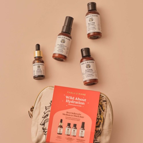 Four skincare bottles and a cosmetic bag with a label about hydration and hair care.