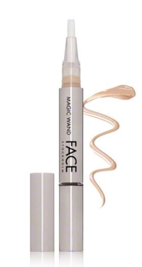 Ein weißes Make-up-Produkt, das wie ein Stift aussieht, mit beige Flüssigkeit daneben.