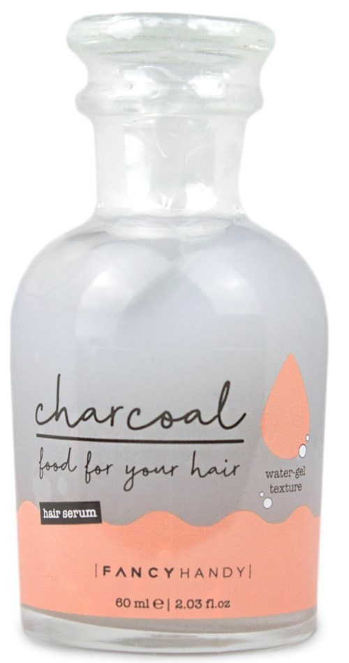 En liten glasflaska med etiketten 'charcoal food for your hair' innehåller vattengelé till hårserum.