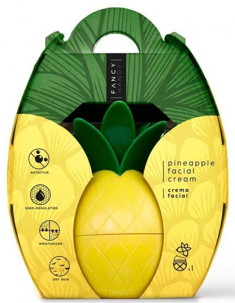 En behållare i form av ananas med lock, gröna blad upptill, och etikett som visar att det är ansiktskräm.