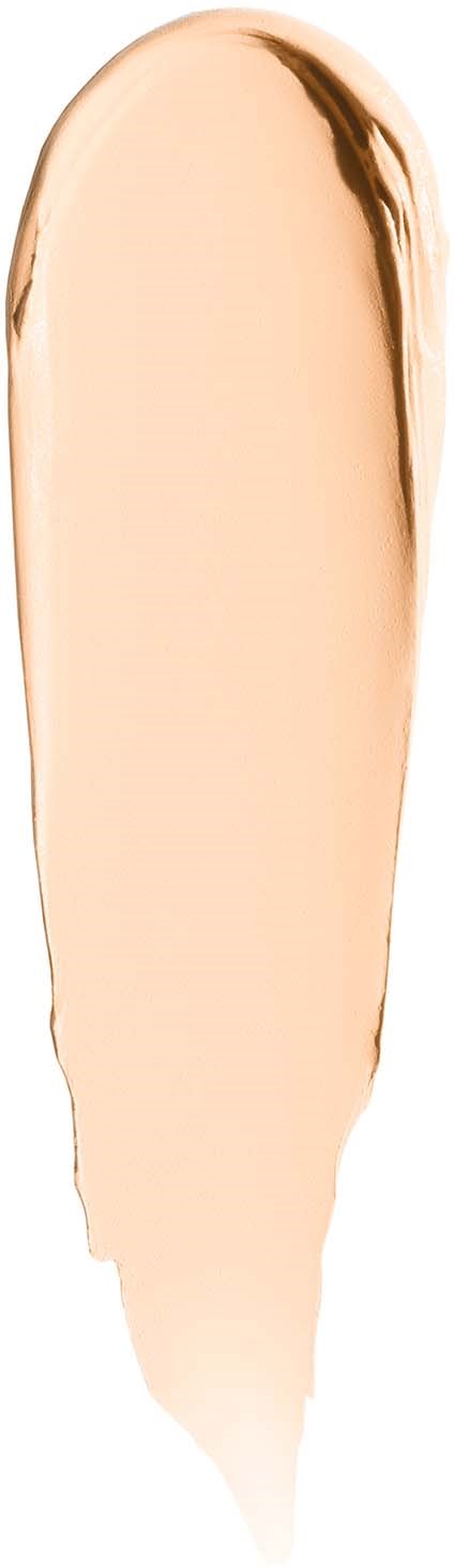 Beige meikkinäyte tummanruskealla reunalla, muodoltaan kyynel.