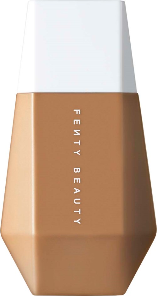 A bottle of Fenty Beauty foundation with a white cap and tan body, shaped like a hexagon.