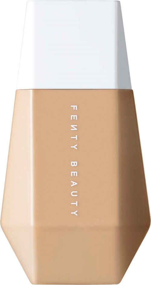 A bottle of liquid foundation with a beige body and white cap, labeled 'Fenty Beauty' vertically.