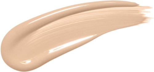 A beige-colored cream or foundation spread in a curved streak on a black background.