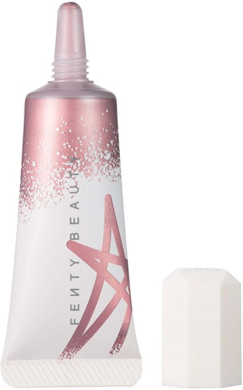 Eine rosa-weiße Tube mit Deckel, vermutlich ein Kosmetik- oder Hautpflegeprodukt, mit einem Plastikschwamm daneben.