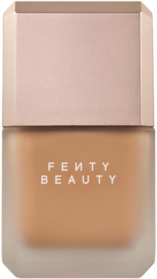 Fenty Beauty-foundationsflaska med ljusrosa lock och beige vätska inuti.
