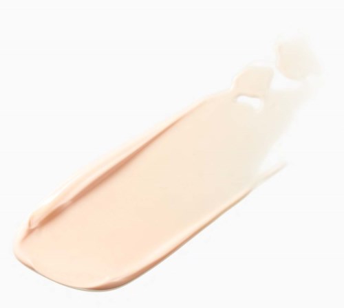 A light beige cream or lotion being spread with a spatula.