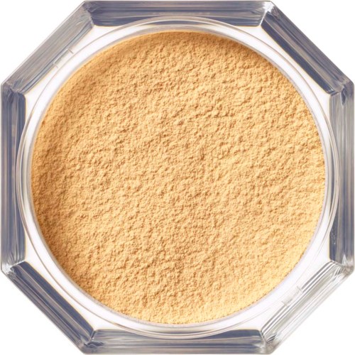 A round, open container filled with beige powdered substance, made of clear material with a geometric edge.