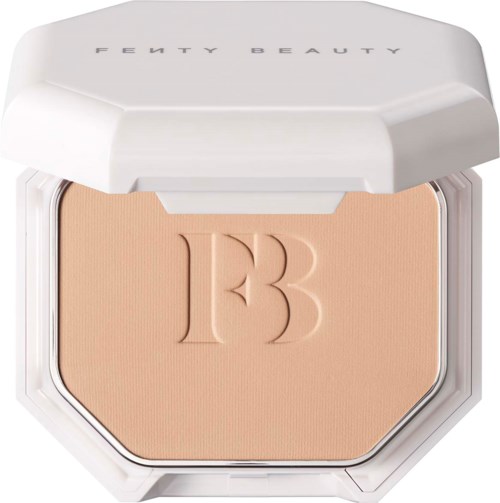 A compact powder with a white lid, embossed with the letter 'B', inside a clear container.
