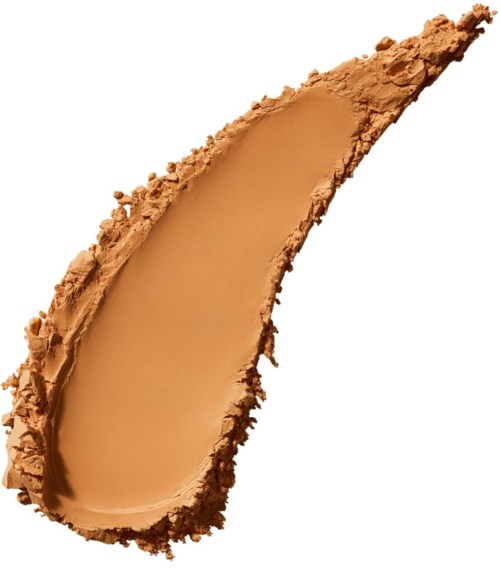 En smear av beige foundationsmink med ofullständiga kanter, formad i en kurvig, förlängd form.