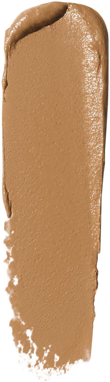 En beige eller ljusbrun krämig substans utbredd i en långsträckt form.