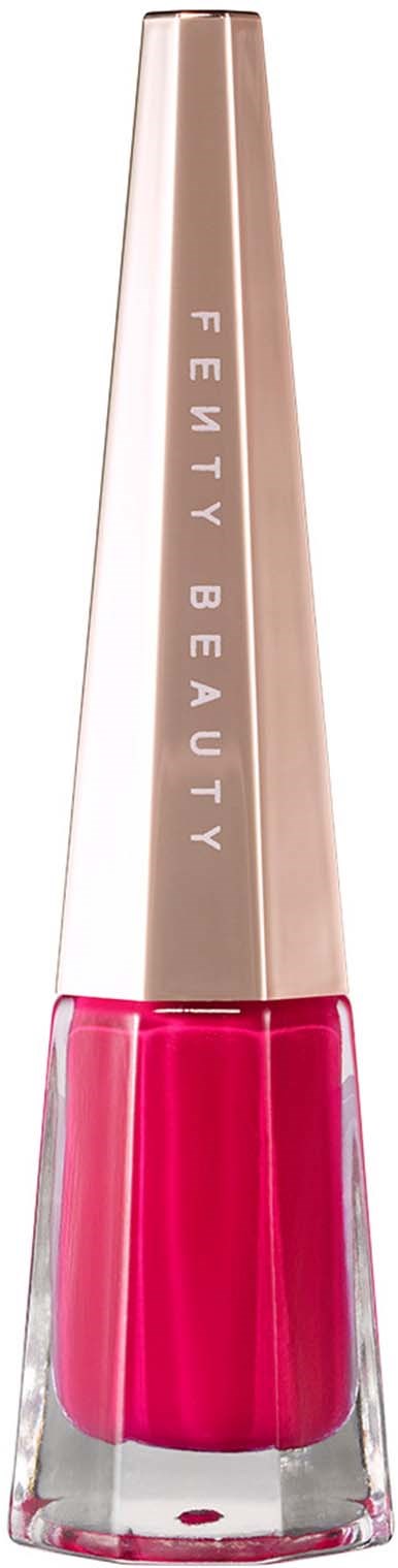 Fenty Beauty nail polish bottle with pink color. Tall, slim gold cap and clear glass base. Logo on cap.