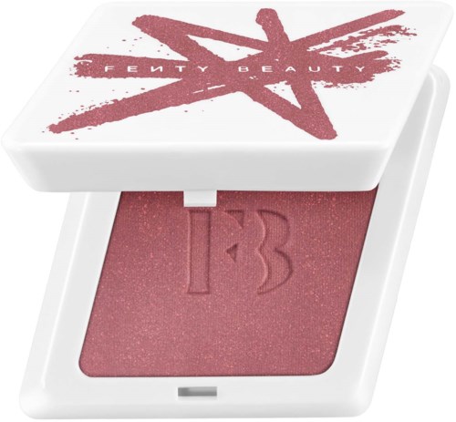 A makeup compact with a pink blush and a white case featuring red star and text design.