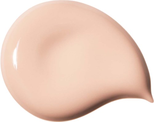 Ett beige flytande foundation dropp med glansig yta och slät textur.