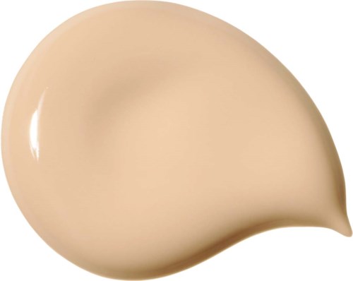 Ett beige flytande foundationmärke med en glänsande, slät yta och en rund form.