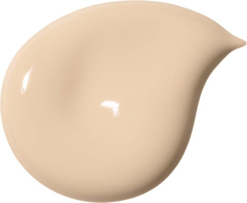 Ett beige, tårtpunktsformat föremål med spets på ena sidan och en rundad bas.