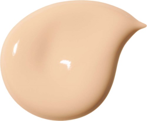 Ett beige flytande foundation-drop med en slät, glänsande yta och en rundad, något spetsig ände.