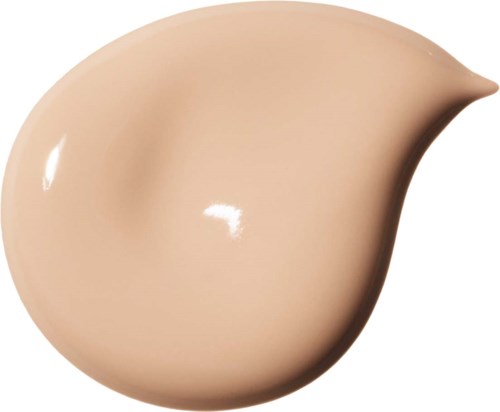 En beige makeup-svamp i tårform med rund botten och spetsig topp.