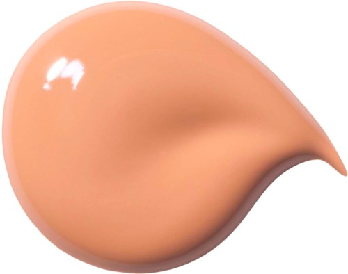 En klick av beigefärgad kräm eller lotion med glänsande yta och spetsig ända.