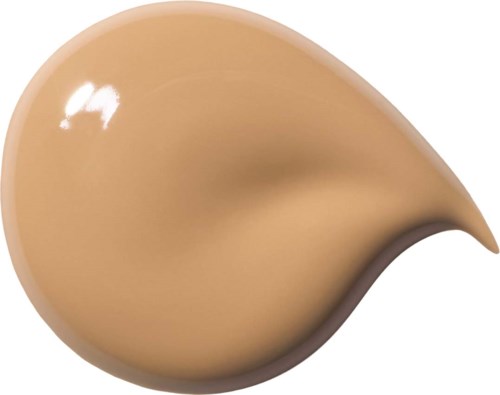 En beige, tårformad flytande foundation eller concealer med en glänsande yta.
